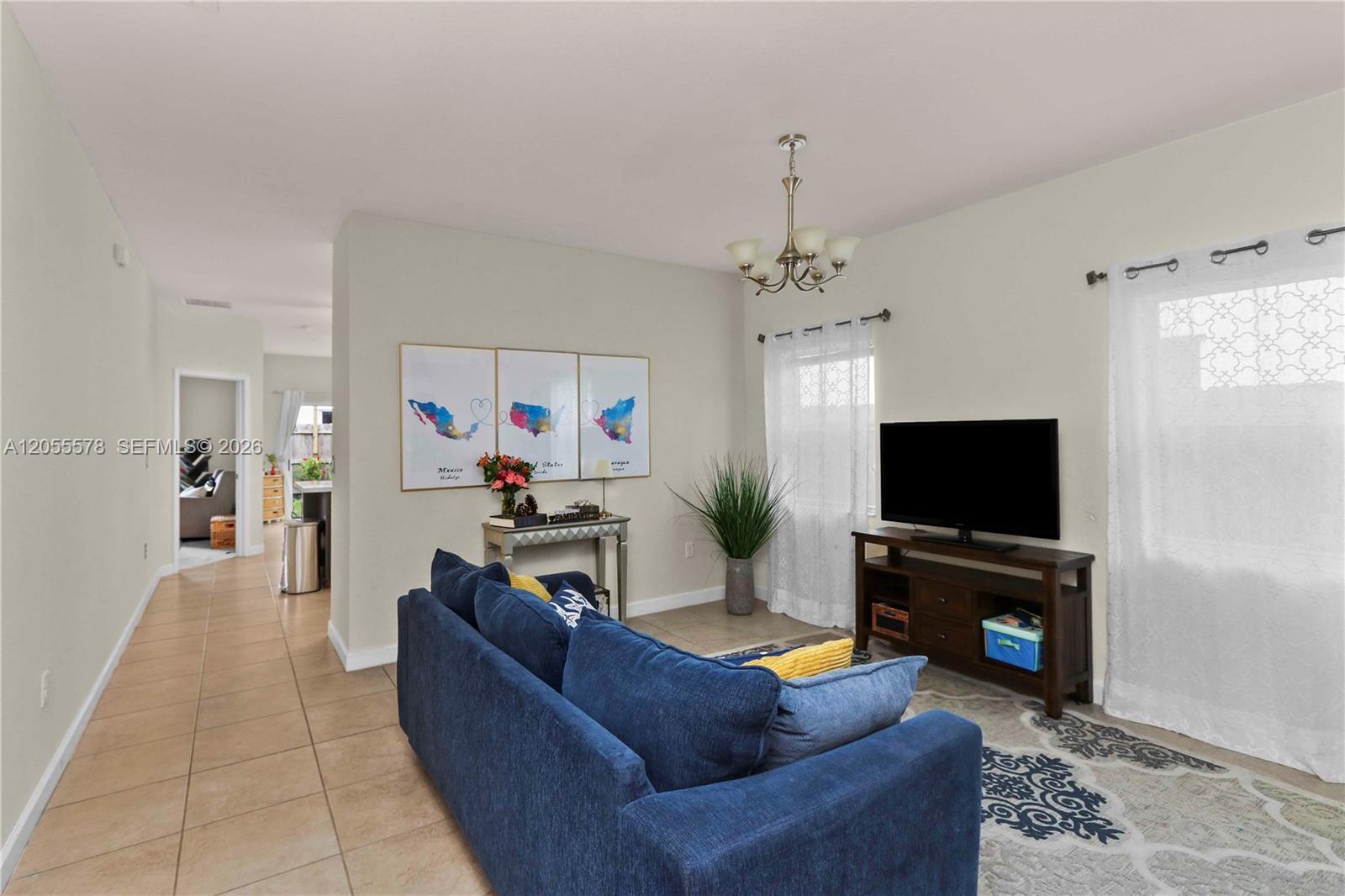 Image 4: Designed for effortless living, this open floor plan provides a seamless flow from the living area t