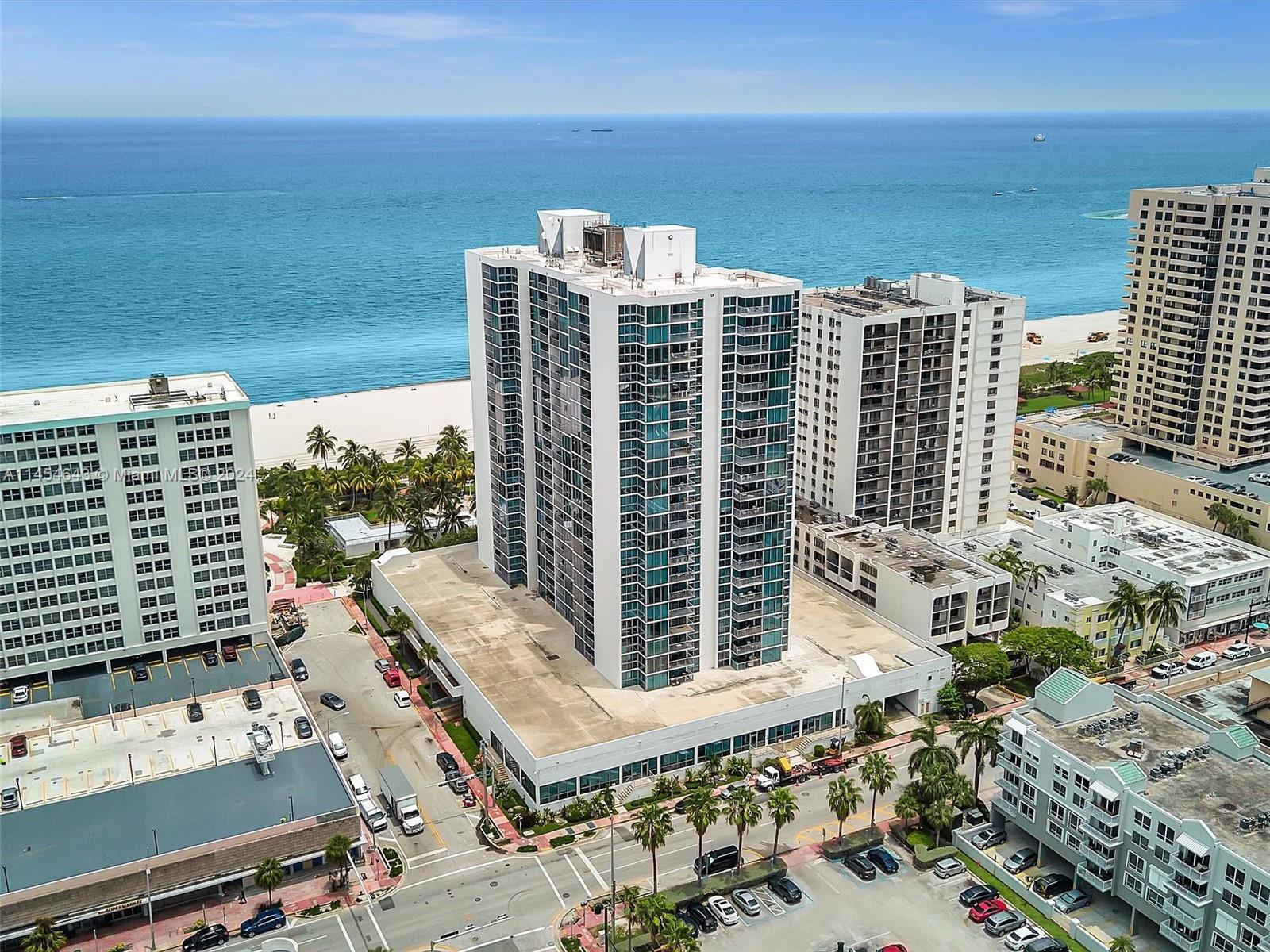 Image 1: Direct oceanfront building; pool and boardwalk.