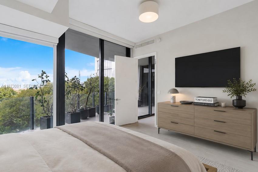 Image 1: Floor-to-ceiling glass, treetop views, and a private terrace &mdash; the primary suite that makes mo