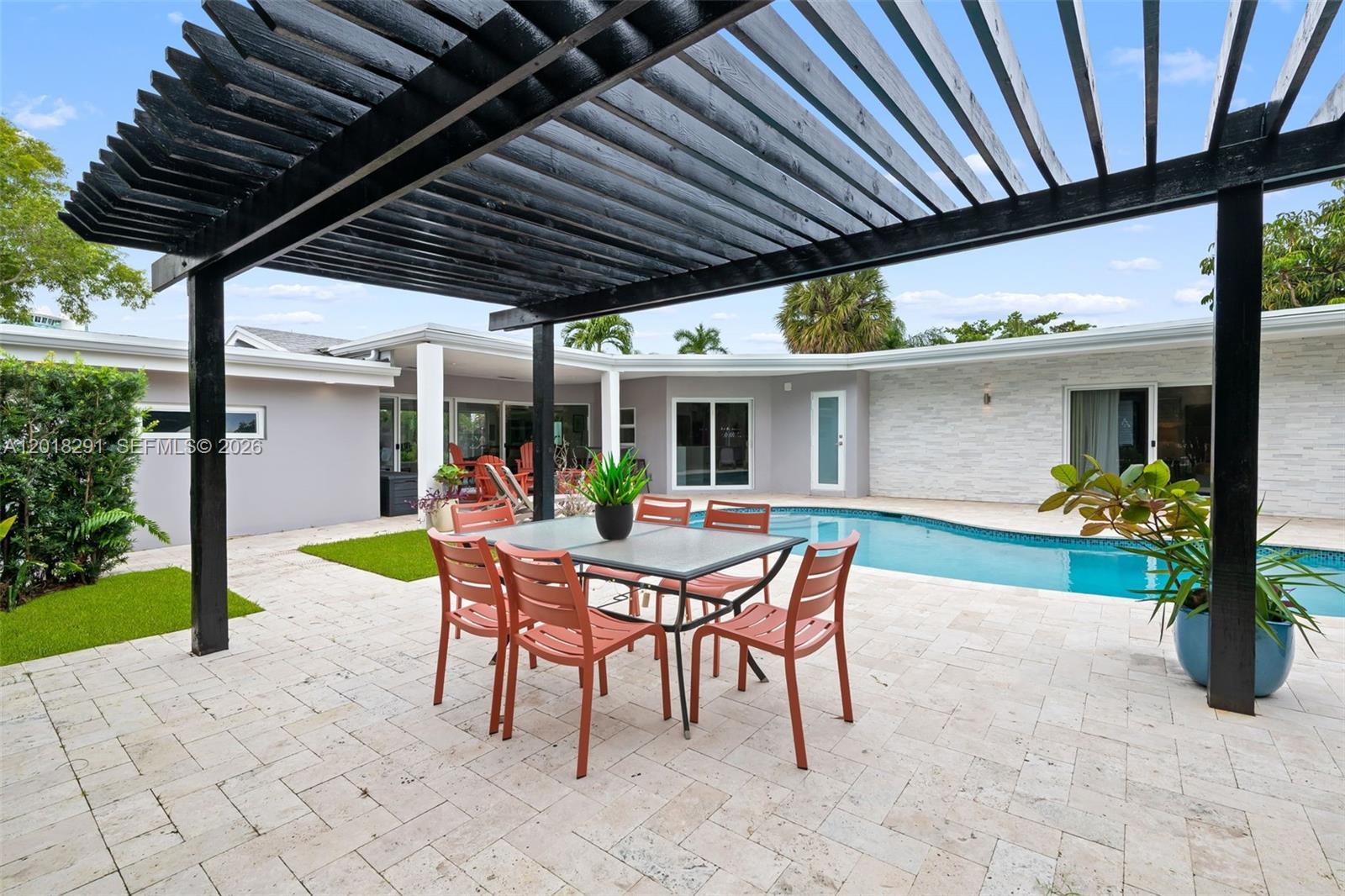 Image 3: Outdoor oasis featuring pergola