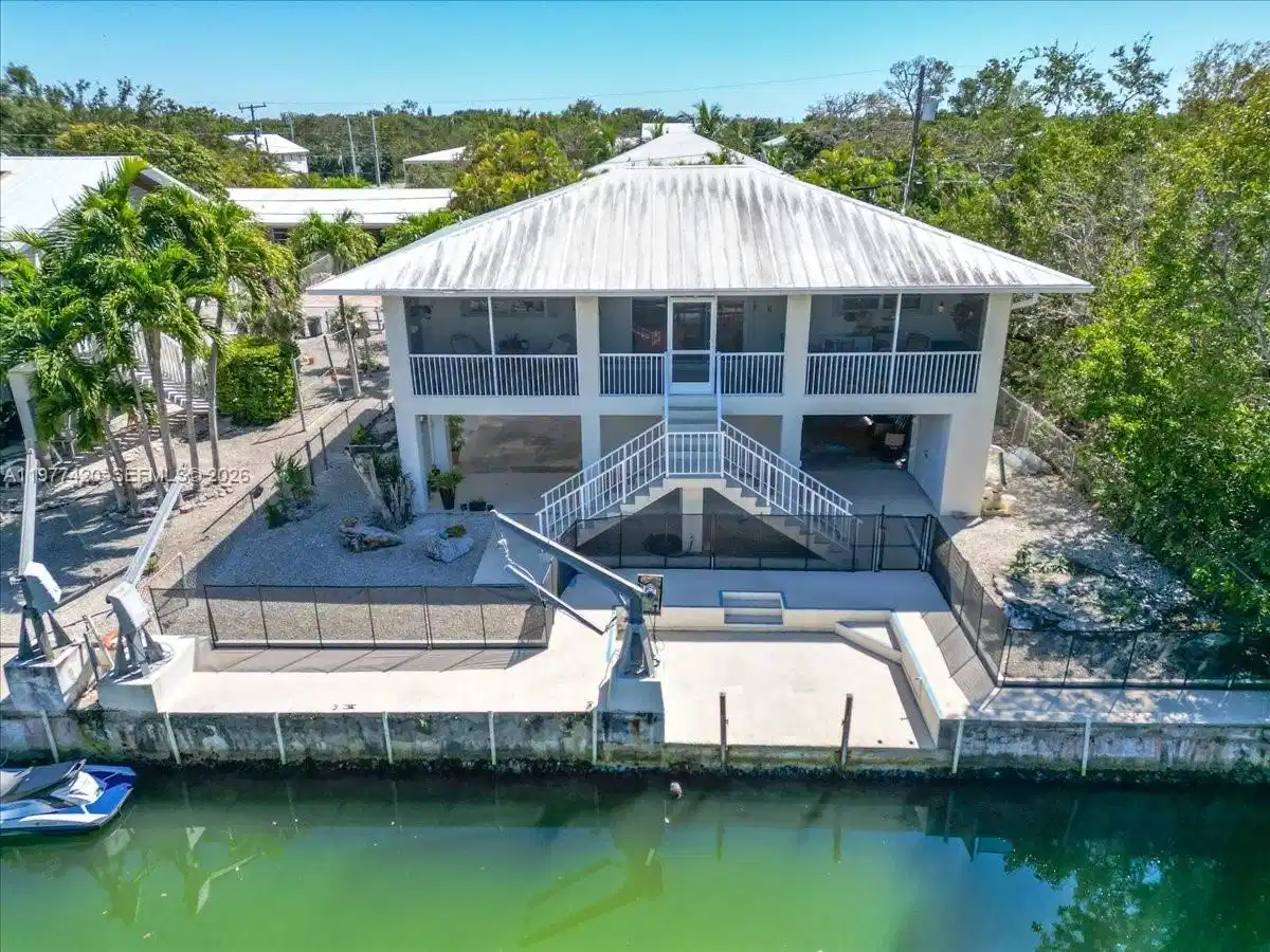 Image 1: Florida Keys waterfront home in Big Pine Key featuring canal frontage and a full concrete seawall wi