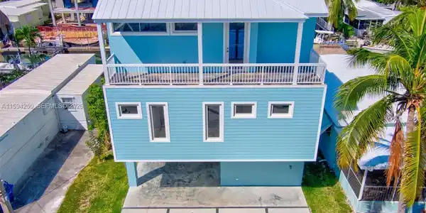 Image 3: Front of home. Balcony top floor