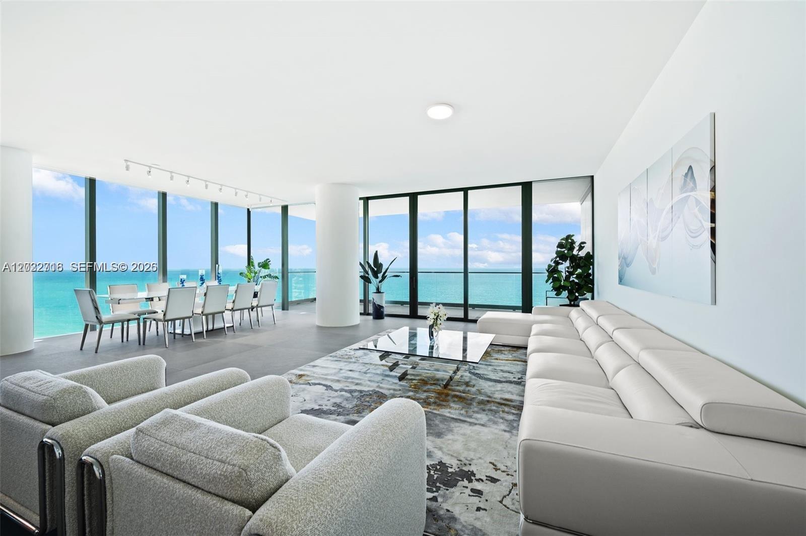Image 1: Direct ocean views from the spacious living area with floor-to-ceiling glass.