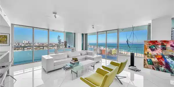 Image 3: Walls of floor to ceiling glass frame the ocean, beach and SoBe skyline