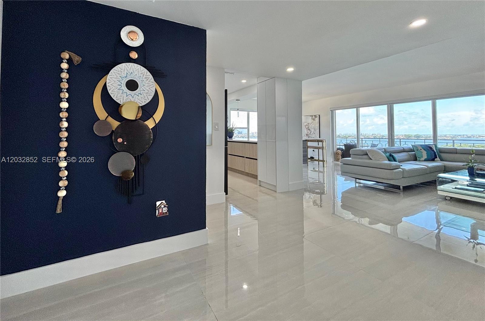 Image 2: Elegant modern coastal-style entryway featuring artistic ocean-inspired details and an atmosphere of