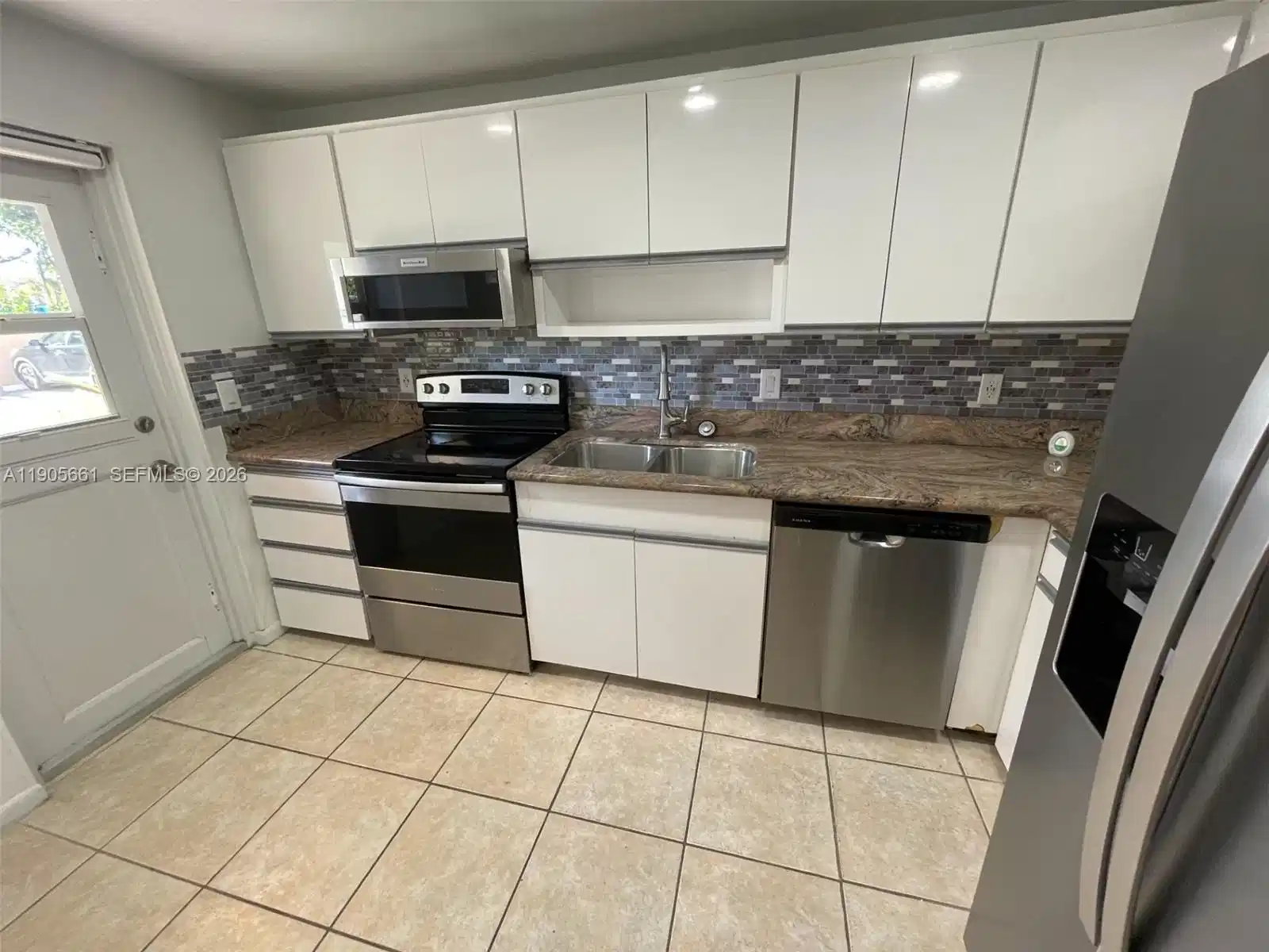 Image 1: Kitchen with New Stainless Steel Appliances and Recessed Ceiling Lights