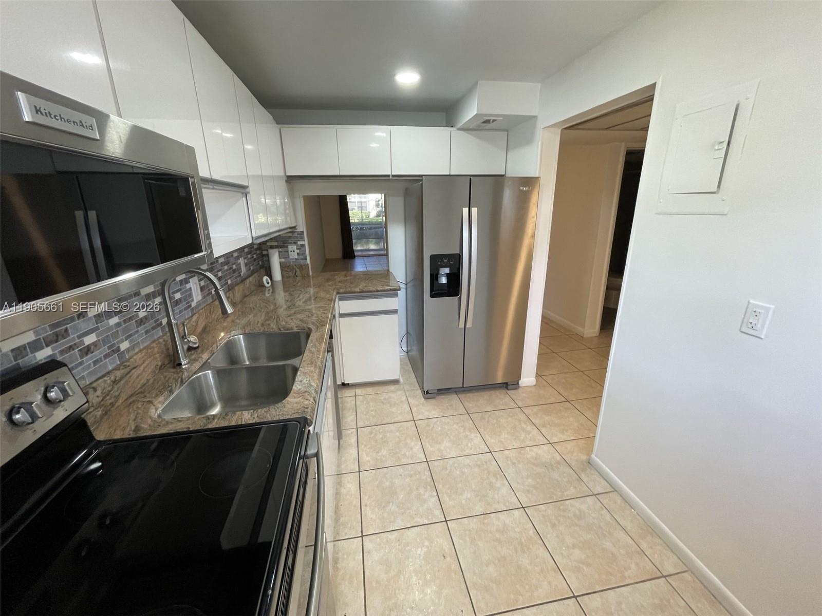Image 2: Kitchen with New Stainless Steel Appliances and Recessed Ceiling Lights
