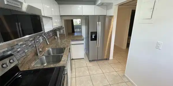 Image 2: Kitchen with New Stainless Steel Appliances and Recessed Ceiling Lights