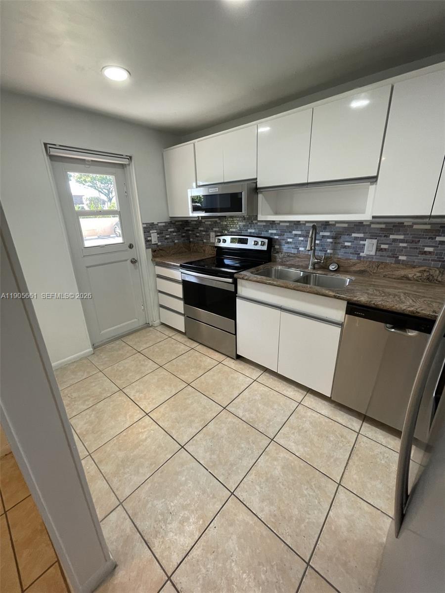 Image 3: Kitchen with New Stainless Steel Appliances and Recessed Ceiling Lights