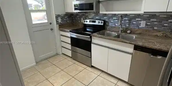 Image 3: Kitchen with New Stainless Steel Appliances and Recessed Ceiling Lights