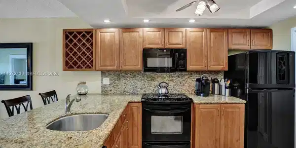 Image 4: Full size washer in Kitchen behind cabinets