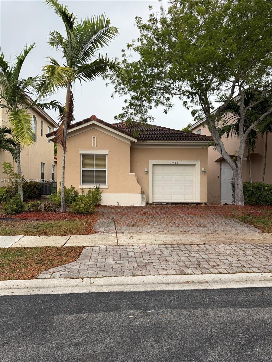 Image 1: This photo shows the 1-car garage and 2-car front driveway.