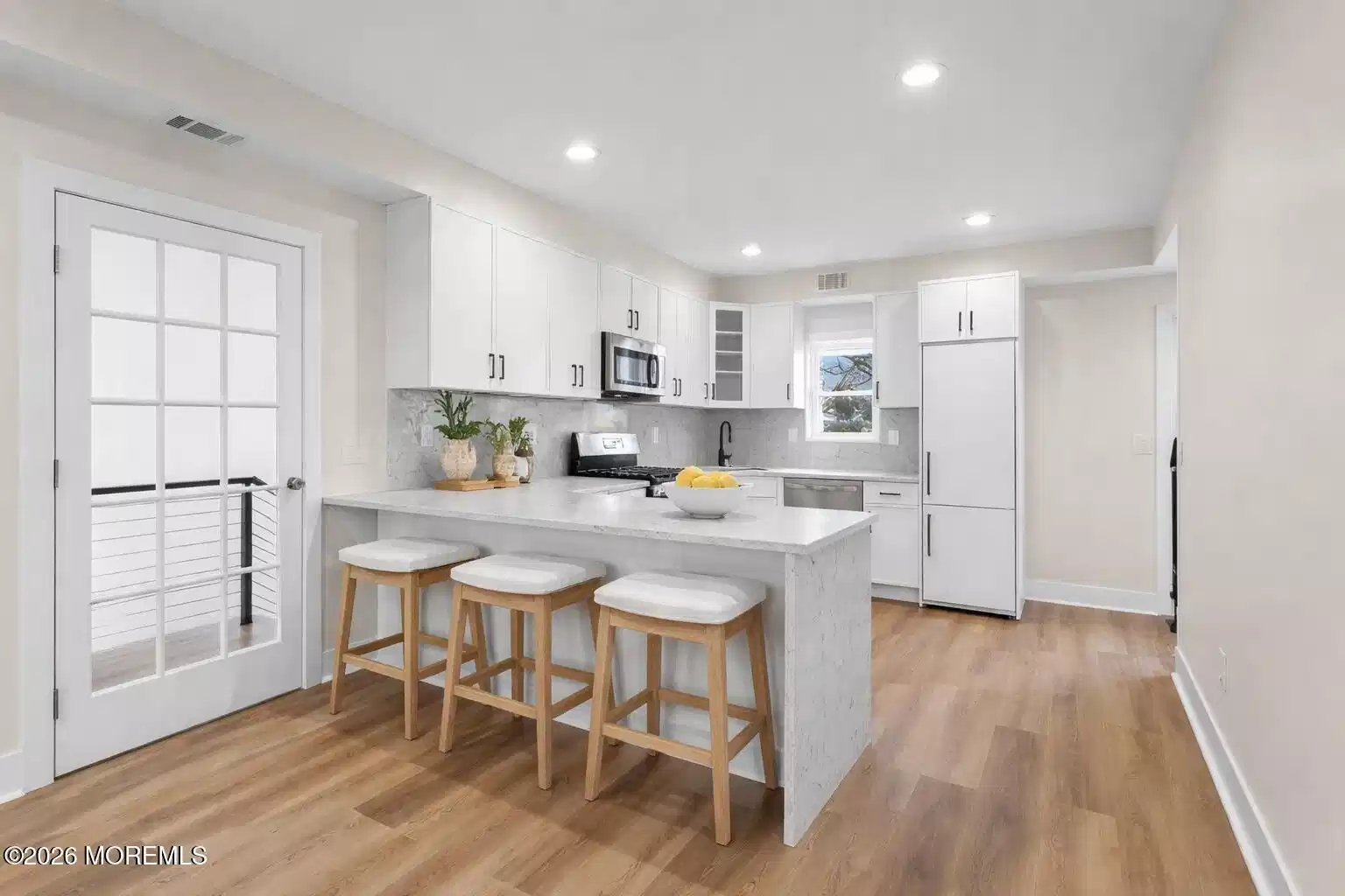 Image 1: Coastal farmhouse kitchen with island