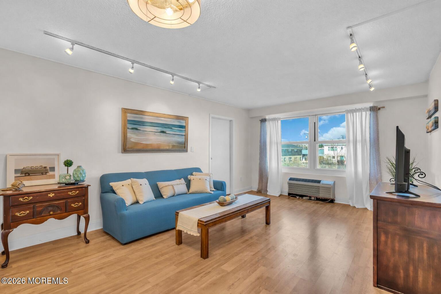 Image 2: Bright, airy living room with beach them
