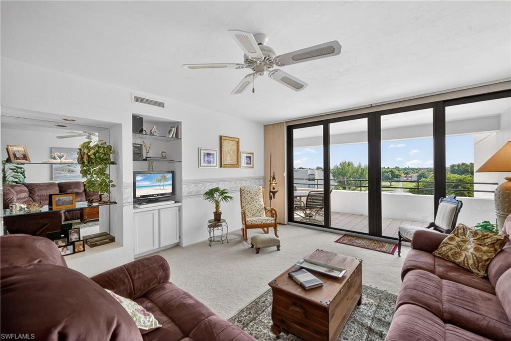 Image 2: Living room with Hurricane Impact Sliders onto Spacious Balcony