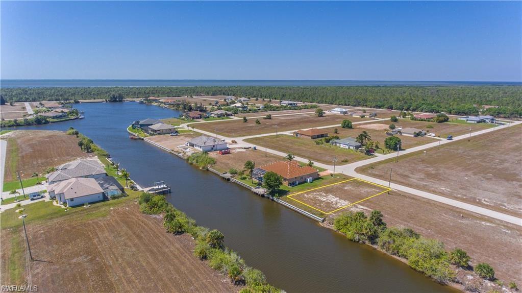 Image 2: Aerial view of residential area featuring a large body of water
