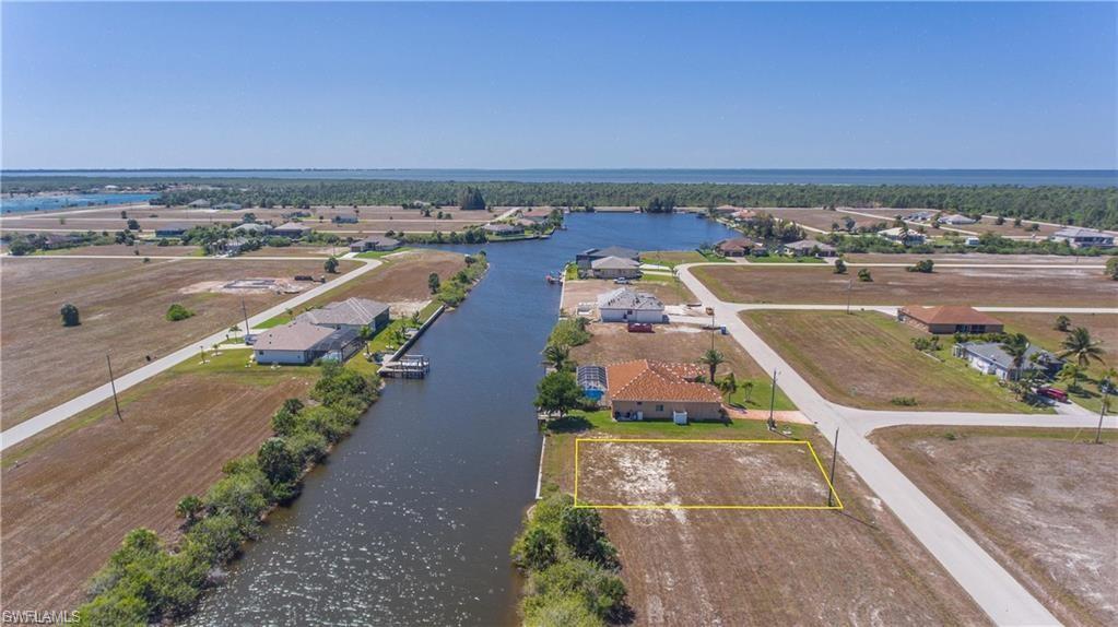 Image 4: Aerial perspective of suburban area with a nearby body of water