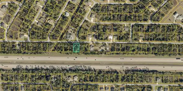 Image 2: Aerial Map. Depicting the property highlighted in green, adjacent to a major roadway, within a residential subdivision