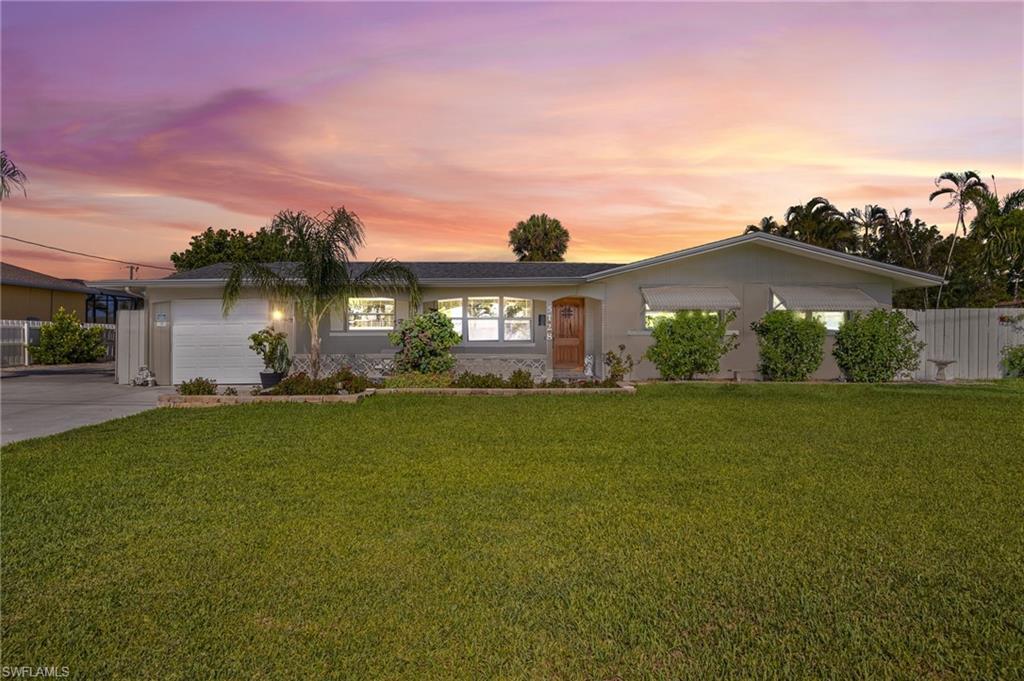 Image 2: Ranch-style house featuring a garage and concrete driveway