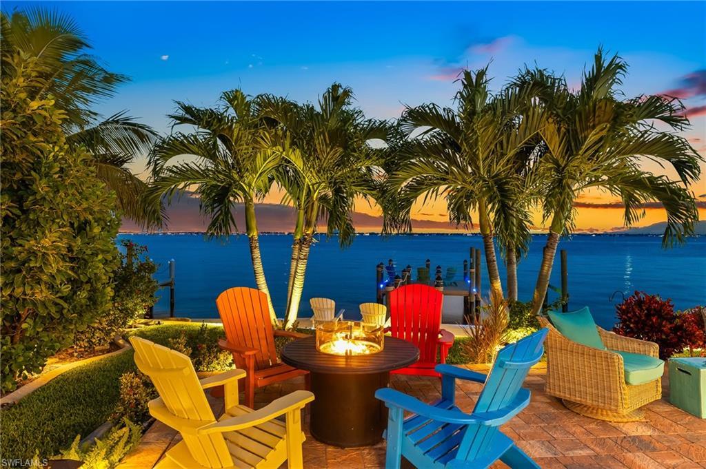 Image 4: View of patio featuring a water view and a fire pit