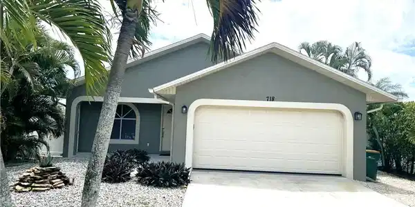 Image 3: Single story home with an attached garage, stucco siding, and concrete driveway