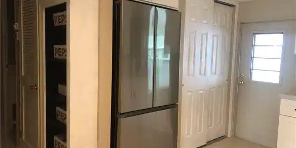Image 2: Kitchen featuring white cabinetry with quiet close, stainless steel refrigerator, and light tile patterned flooring