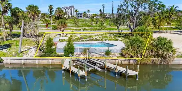 Image 3: Dock featuring a water view and boat lift  - Virtually Edited Image