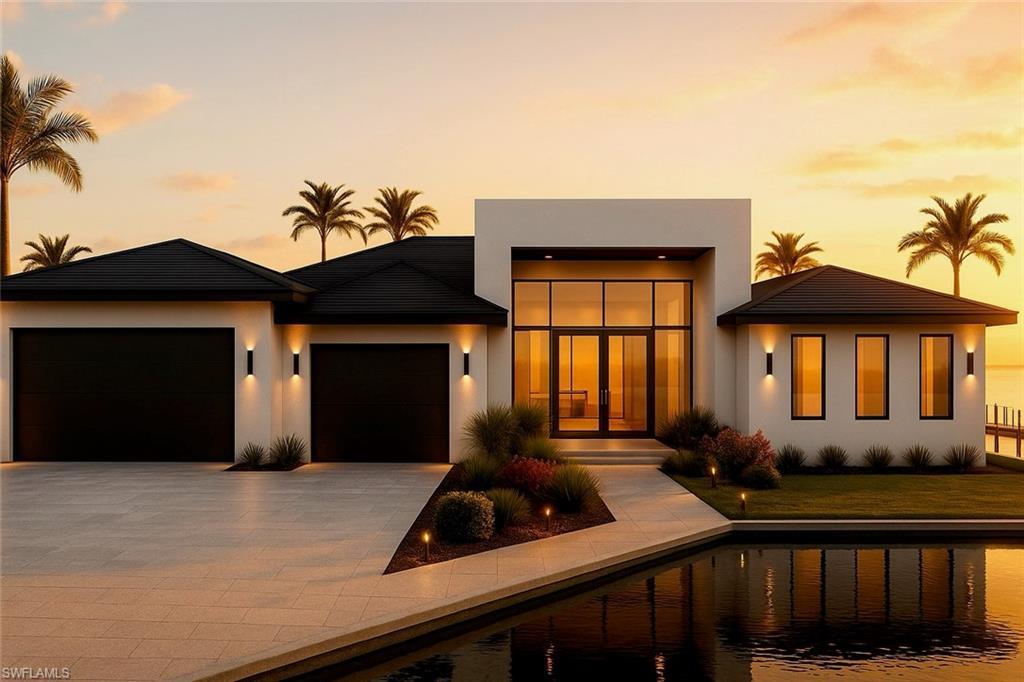 Image 1: View of front of home featuring an attached garage, driveway, and stucco siding