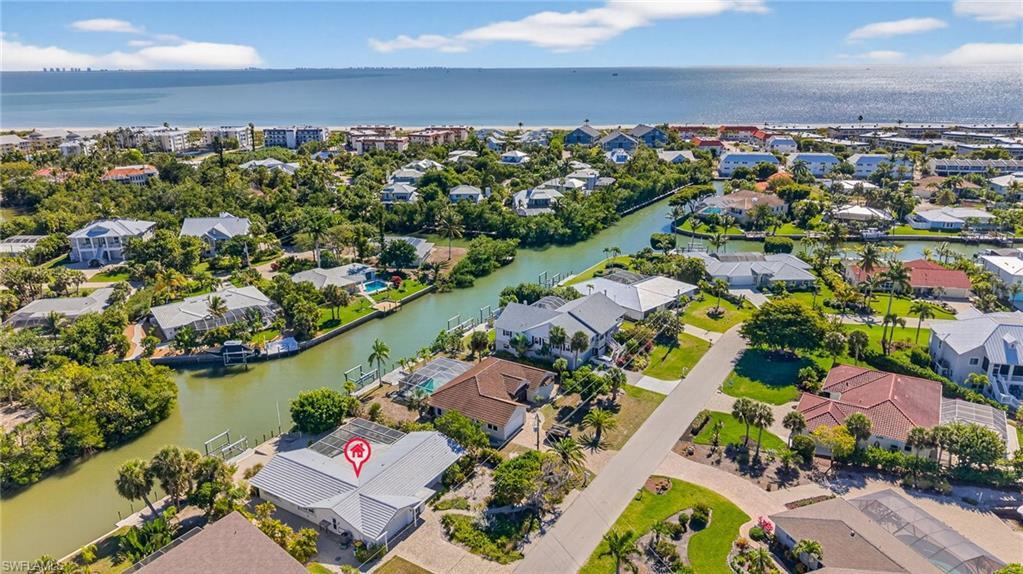 Image 2: Aerial view of residential area with a nearby body of water