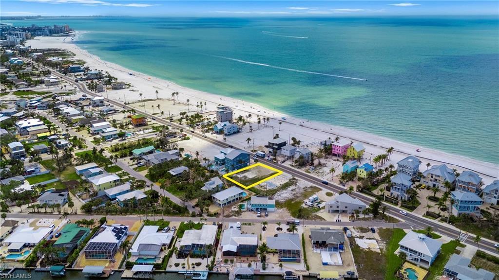 Image 1: Cant beat this location, Aerial view with a water view, a residential view, and a view of the beach  - Virtually Edited Image