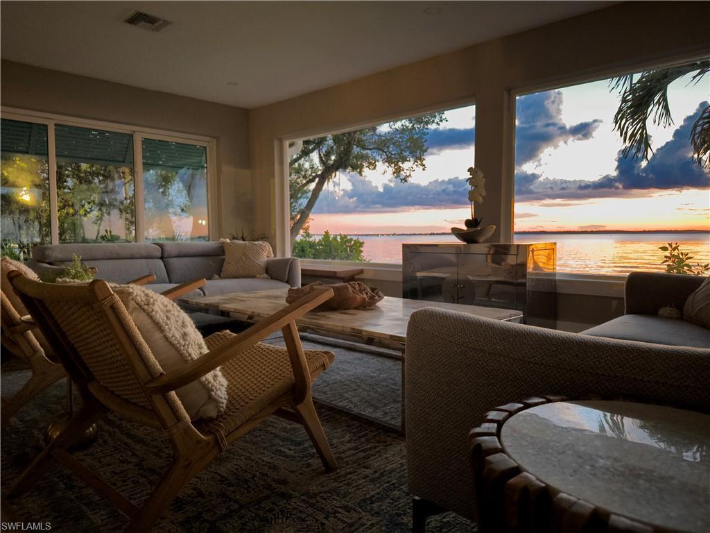 Image 1: Sunroom featuring a water view