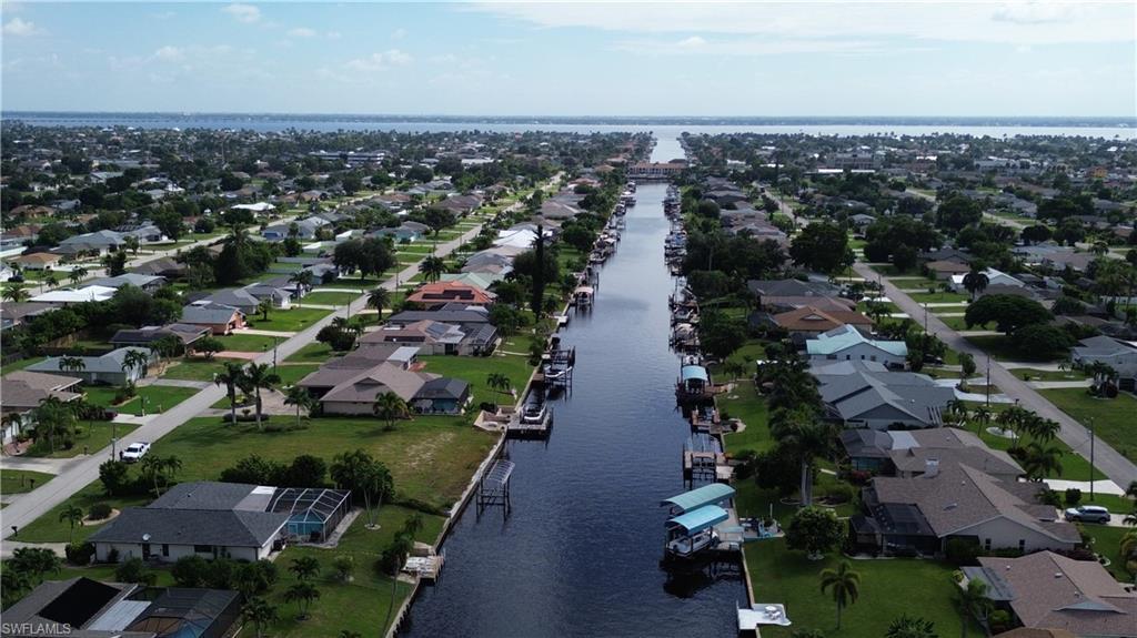 Image 3: View of property location featuring a large body of water and nearby suburban area