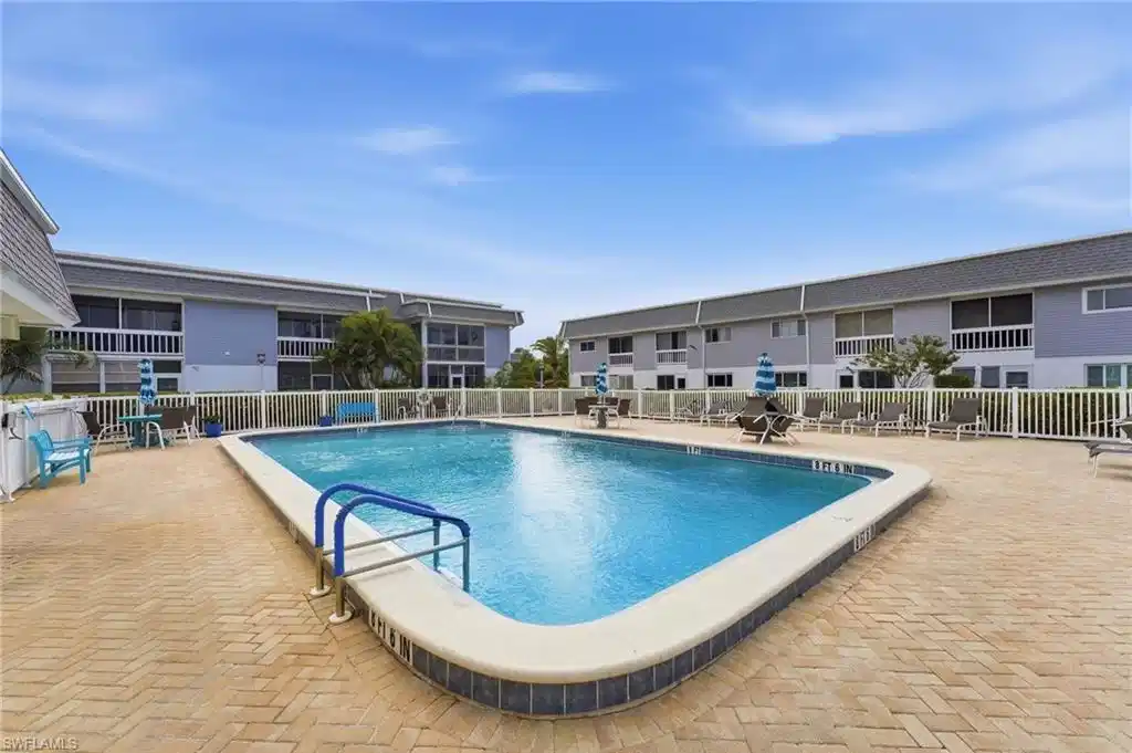Image 1: Community pool with a patio area