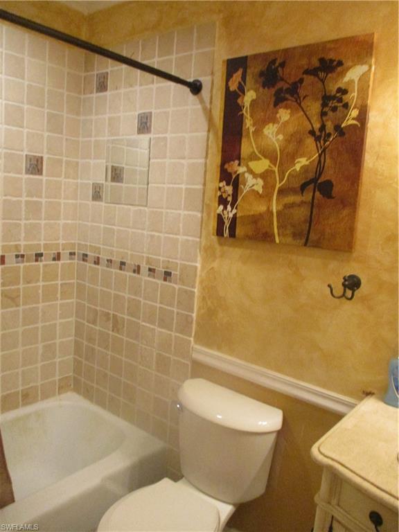 Image 4: Full bathroom featuring tiled shower / bath combo, vanity, and toilet