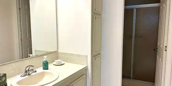 Image 4: Full bath featuring a shower stall, vanity, and light tile patterned floors