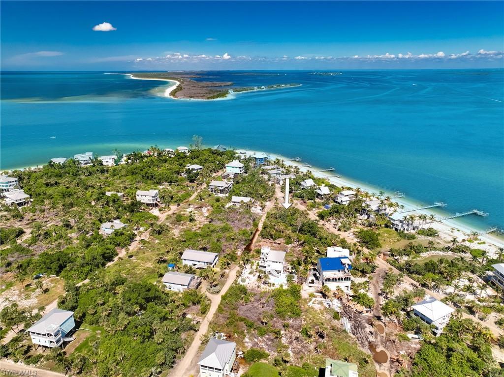 Image 2: Birds eye view of property featuring a water view and a view of the beach