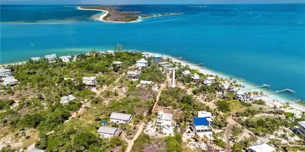 Image 2: Birds eye view of property featuring a water view and a view of the beach