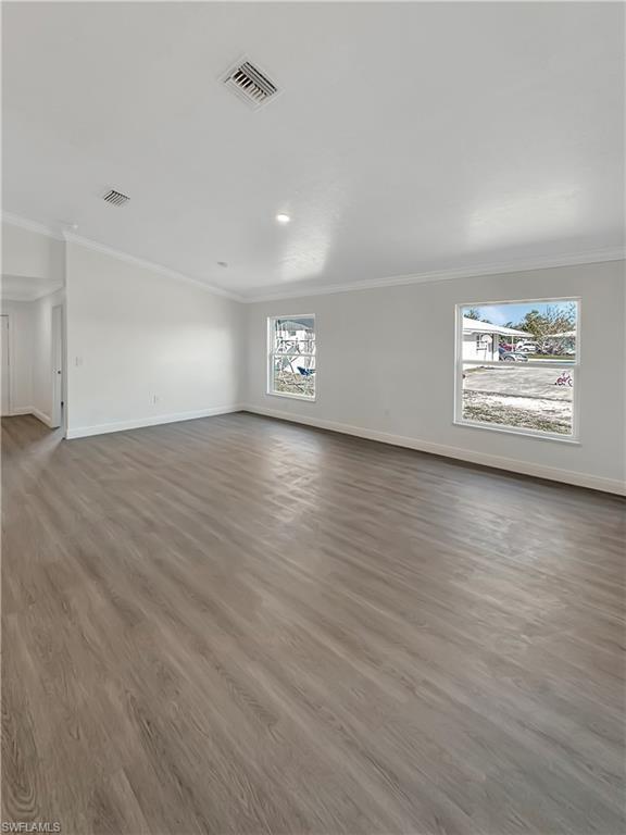 Image 4: Spare room featuring dark wood-style floors and ornamental molding
