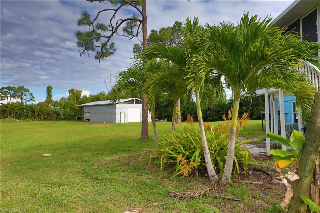 Image 4: View of green lawn featuring an outdoor structure