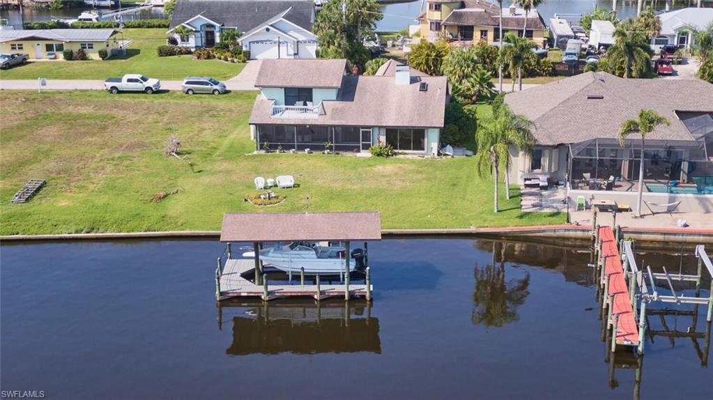 Image 2: Dock area featuring a water view and a yard