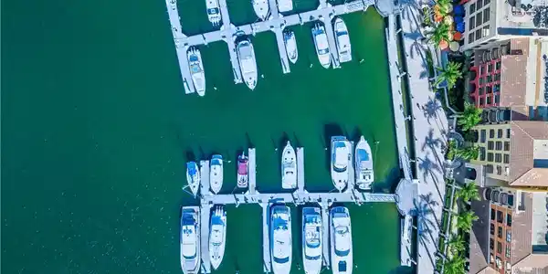 Image 4: Aerial view of numerous boat docks and a nearby body of water