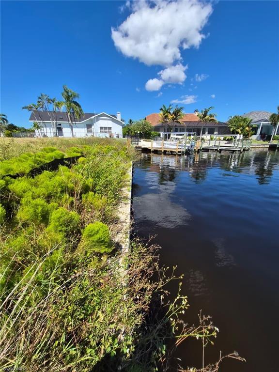 Image 2: Water view featuring a dock