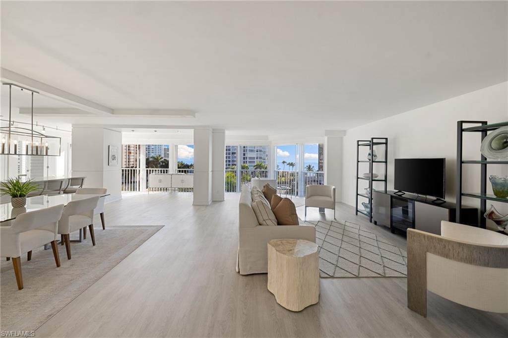 Image 4: Living room featuring light wood-style floors, plenty of natural light, and suspended lighting