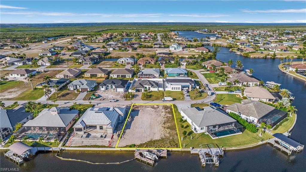 Image 3: Gulf Access lot with seawall, boat dock and lift northeastern rear exposure, about 20 min by boat to open water. 907 NW 38th Ave, Cape Coral FL 33993