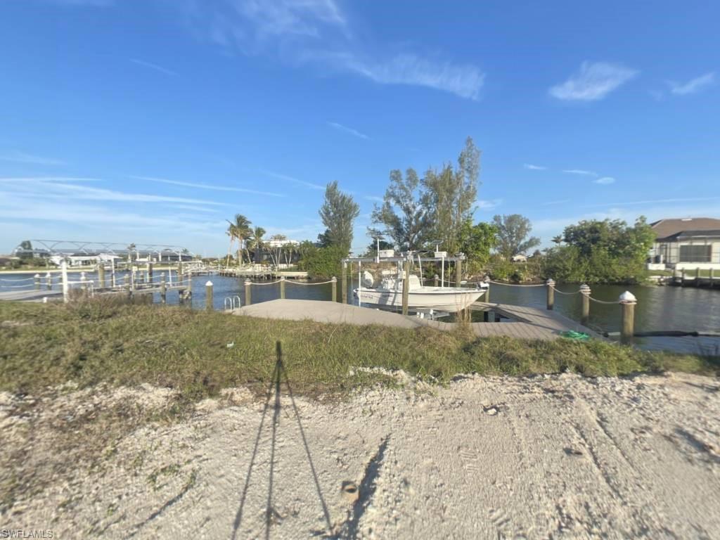 Image 4: Gulf Access lot with seawall, boat dock and lift northeastern rear exposure, about 20 min by boat to open water. 907 NW 38th Ave, Cape Coral FL 33993