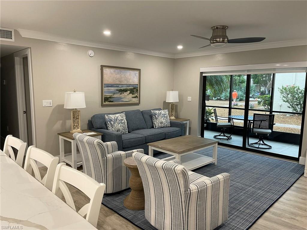 Image 4: Living area with ornamental molding, recessed lighting, wood finished floors, and a ceiling fan