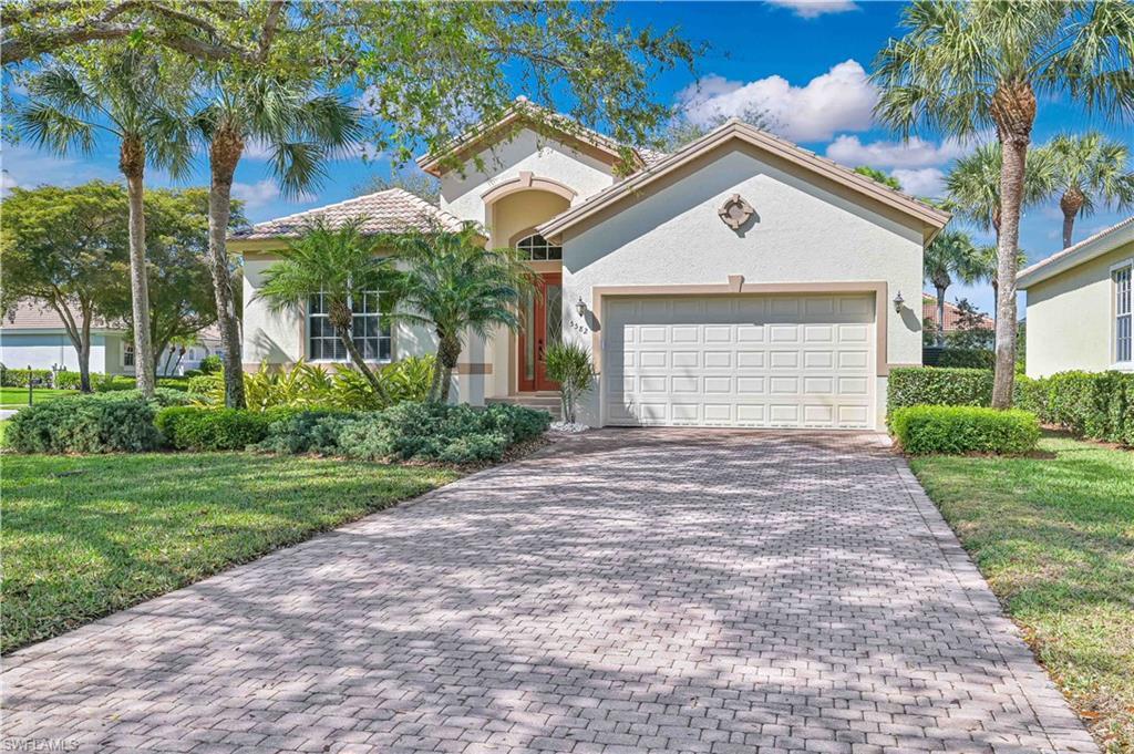 Image 4: Mediterranean / spanish-style home featuring a front lawn, an attached garage, decorative driveway, and stucco siding