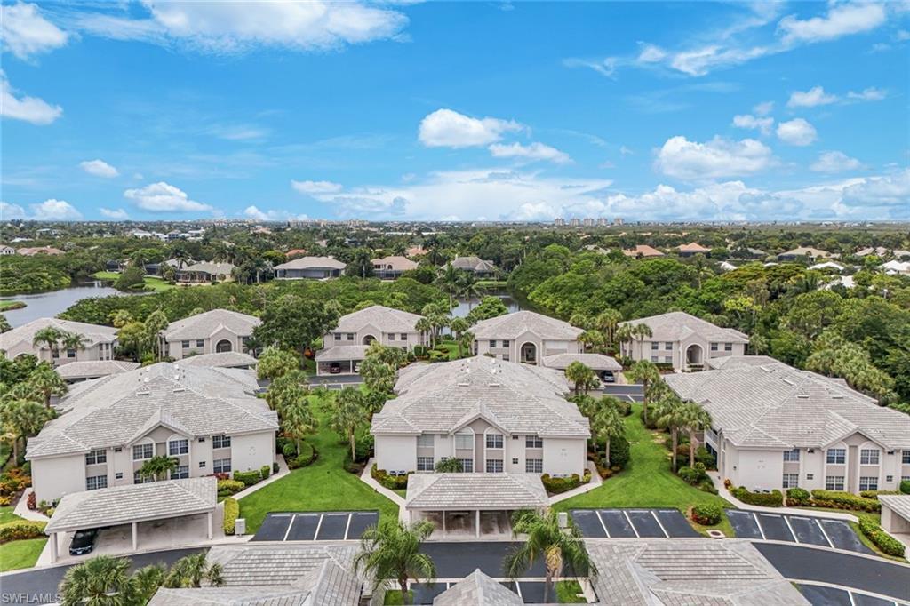 Image 2: Expansive aerial showcasing multiple residential buildings with uniformly tiled roofs