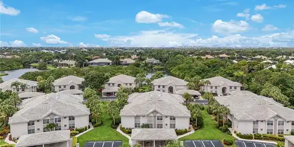 Image 2: Expansive aerial showcasing multiple residential buildings with uniformly tiled roofs