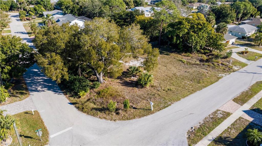 Image 1: Aerial perspective of suburban area with a tree filled landscape